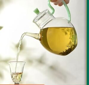 Green tea leaves and a cup of freshly brewed tea