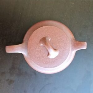 Handmade Yixing Zisha teapot crafted from natural clay with elegant lotus design