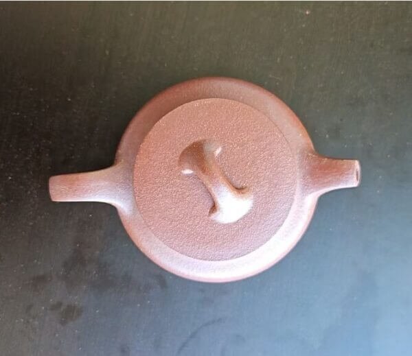 Handmade Yixing Zisha teapot crafted from natural clay with elegant lotus design