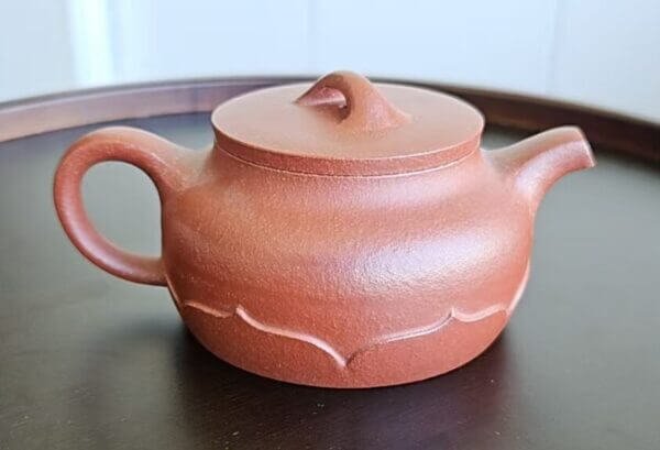 Handmade Yixing Zisha teapot crafted from natural clay with elegant lotus design